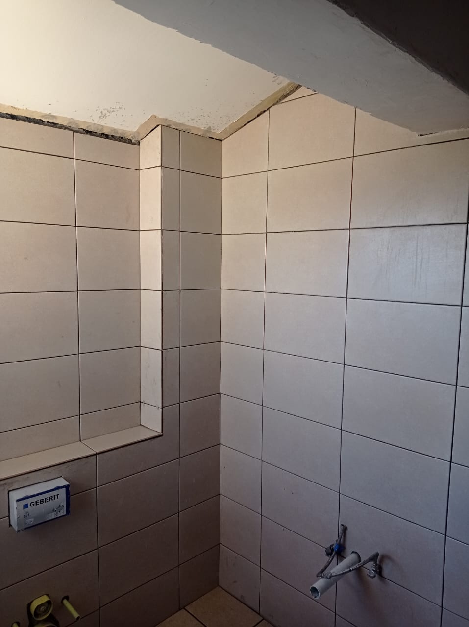 Bathroom wall tiling in progress