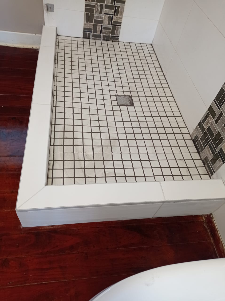 Shower floor and wall tiling — completed finish