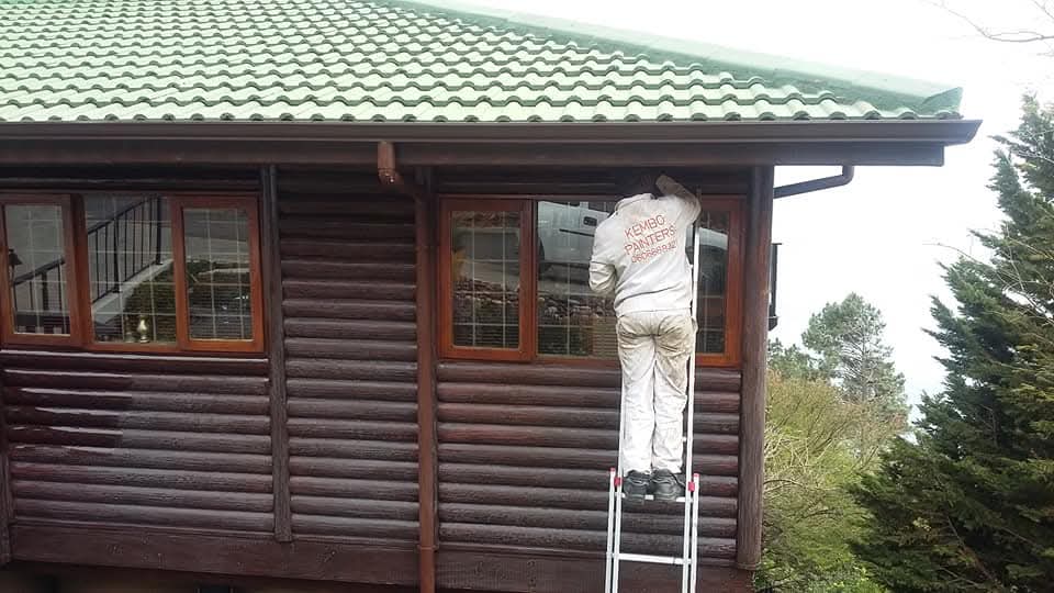 Wood varnish work on exterior log cabin